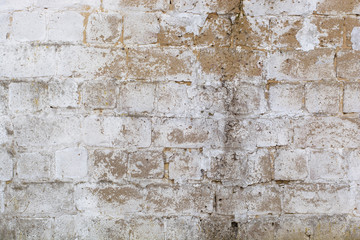 A very old white wall of cinder block