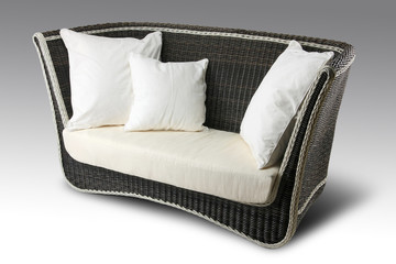 Wicker sofa with pillows