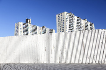 derelict part of coney island boardwalk and apartment buildings