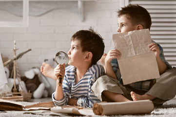 Two boys studying old maps Travel