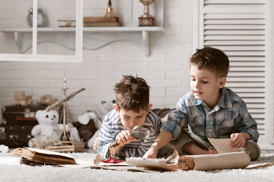 Two boys studying old maps Travel
