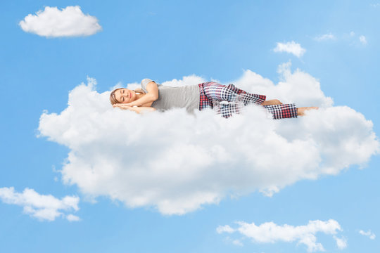 Tranquil scene of a woman sleeping on cloud