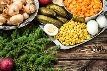 Vegetables for christmas salad on wooden table.