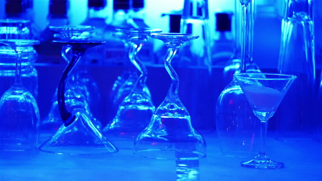 Blue cocktail bar glasses and drinks; panning video.