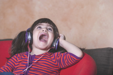 Little girl singing while listening to music