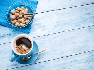 Cup of coffee and cane sugar cubes.