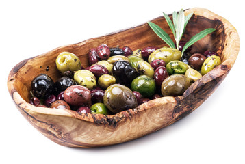 Whole table olives in the wooden bowl on the white background.