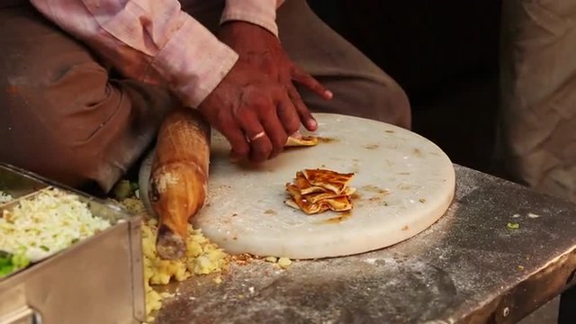 Locked-on shot of a man rolling a paratha, Delhi, India