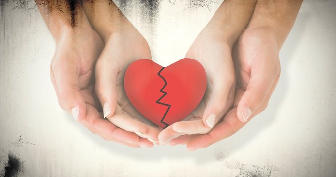 Composite image of couple holding broken heart in hands