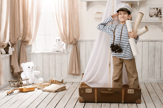 Boy in the image of sailor playing in her room