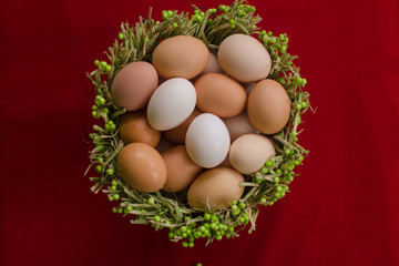 Eggs in a basket on a red background close-up
