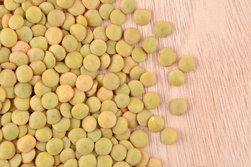 Green lentil on wooden background