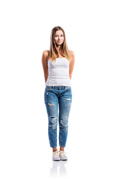 Standing Teenage Girl In Jeans And White Singlet,  Isolated