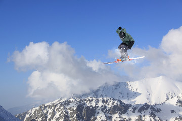 Fototapeta na wymiar Flying skier on mountains. Extreme sport.