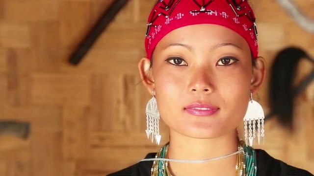 Locked-on shot of a Naga tribeswoman in traditional outfit during Hornbill Festival, Kisama, Kohima, Nagaland, India