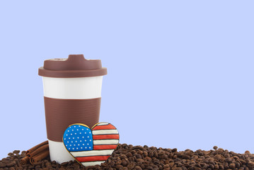 Takeaway ceramic cup and coffee beans on blue background