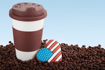 Takeaway ceramic cup and coffee beans on blue background