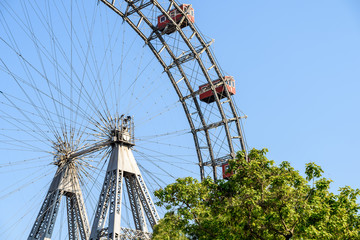 Fun Park Ferris Wheel Against Blue Sky In Vienna Prater Park