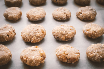 Oatmeal cookies on a baking sheet covered with parchment