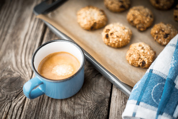 Oatmeal cookies and coffee cup on a wooden table