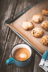 Oatmeal cookies and coffee cup on a wooden table