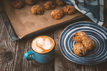 Oatmeal cookies and coffee cup on a wooden table