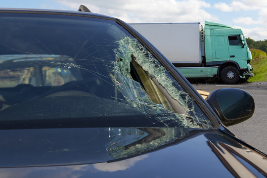 
View of truck in an accident with car, broken glass
