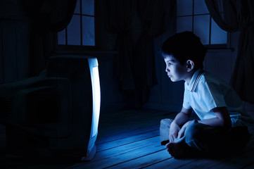 Boy watching TV at night