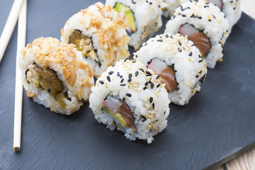 Sushi rolls on a slate plate