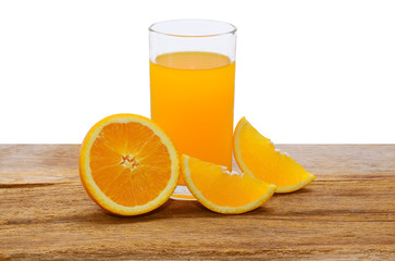 Orange juice and slices of orange on a wooden table.