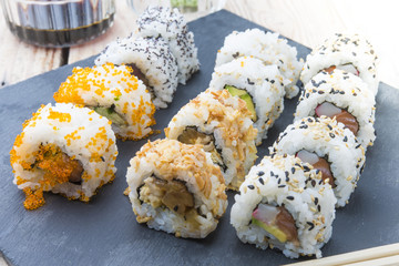 Sushi rolls on a slate plate