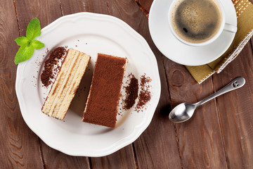 Tiramisu dessert and coffee on wooden table