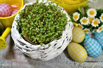 Fresh cress in a wicker basket and Easter blown
