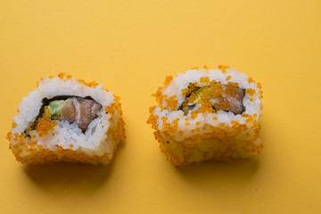 Various kinds of sushi food served on yellow blackground