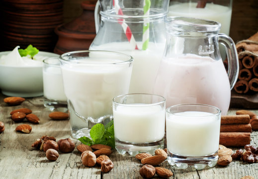 Fresh dairy products and nuts on an old wooden background, selec