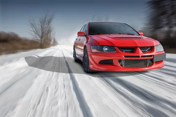 Photo sur Plexiglas Voitures rapides Red sport car driving speed on road at winter daytime
