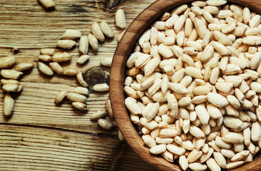 Puffed sweet rice in a round bowl on the old wooden background,