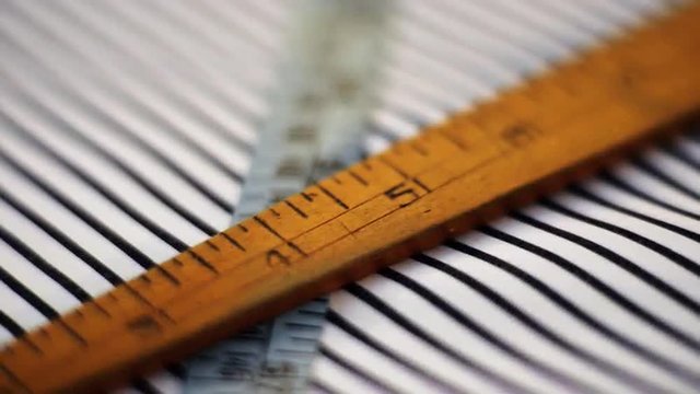 Rack focus shot of measuring instrument in textile factory, Kolkata, West Bengal, India