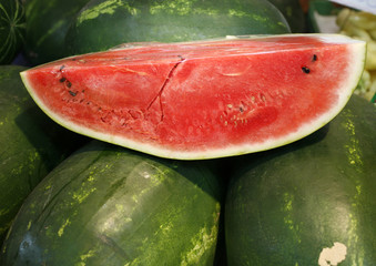 Fresh sweet water melons on market stall as background