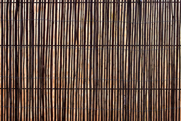  wooden fence made out of canes.
