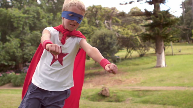 Little boy pretending to be superhero