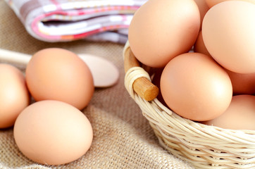 Wicker basket with eggs on a linen tablecloth