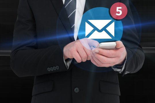 Composite image of businessman sending a text message