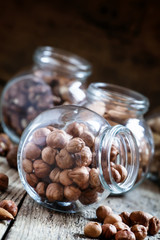 Hazelnut in a glass jar, dark toned image, selective focus