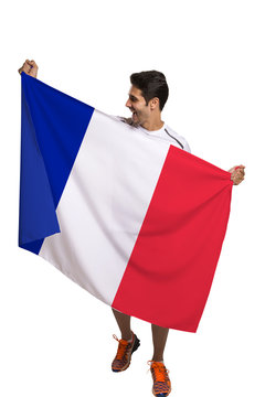 Fan holding the flag of France celebrates on white background