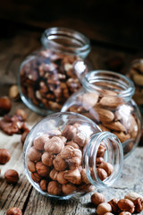 Hazelnut in a glass jar, dark toned image, selective focus