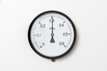 Industrial pressure gauge on a white background