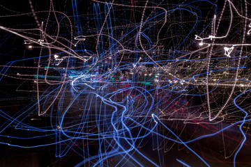 View of an abstract composition of blurry lights on street by moving or shaking camera.
