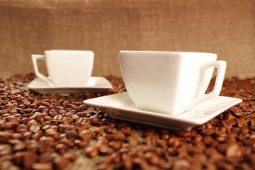 Cups with coffee and coffee beans