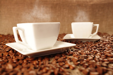 Cups with coffee and coffee beans